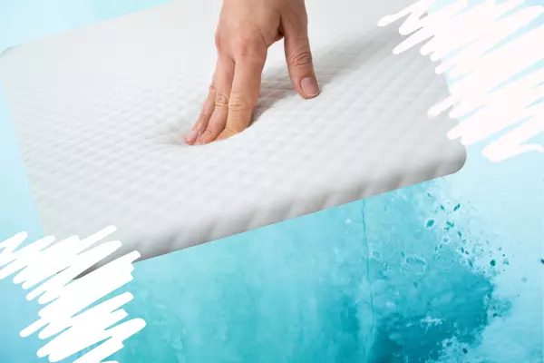 a hand on a memory foam mattress