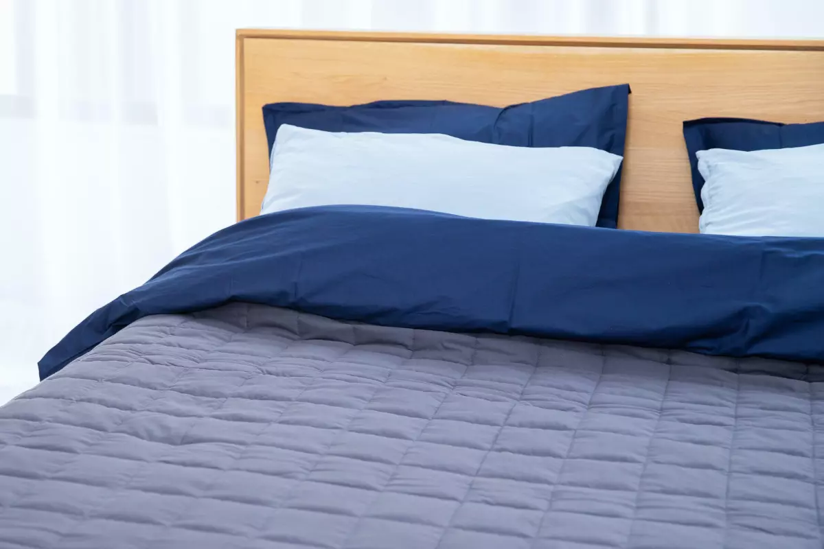 a bed with a blue mattress